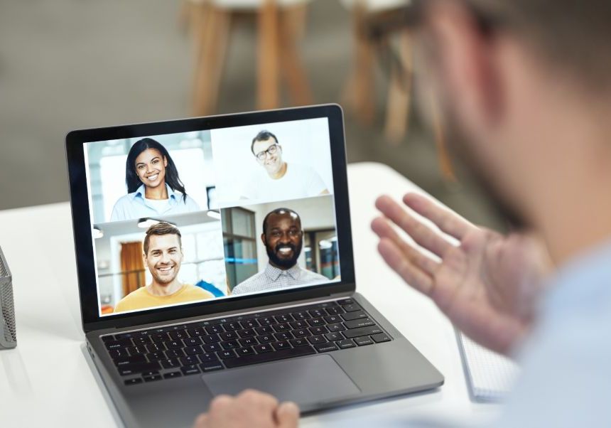 Man holding a video meeting with a laptop.